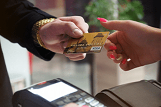 credit card being handed from one hand to another