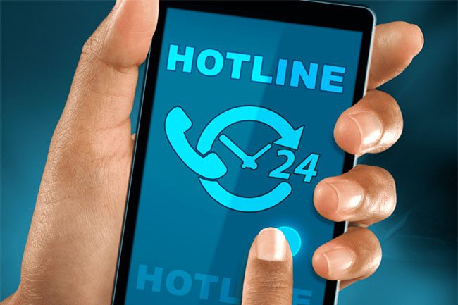 Hand-holding-smartphone-showing-hotline-text-and-24-hour-call-icon. Humach-Omnichannel-Solution-for-City-Disaster-Relief-Hotline-Live-in-24-Hours-Blog-Header