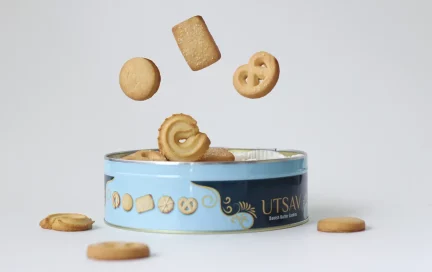 image of cookie tin with cookies falling into the bin.
